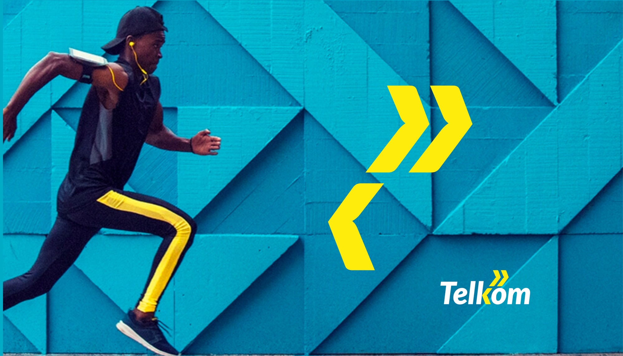 Hero image: a runner in black kit with yellow side stripes sprinting past a turquoise geometric painted wall, with the yellow chevron device and the Telkom logo set to the right