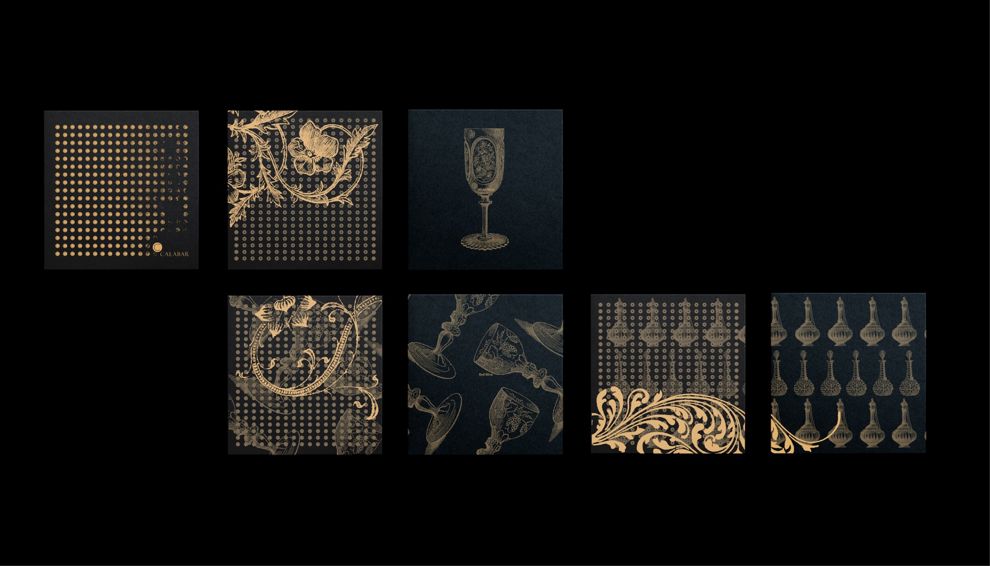 Calabar collateral in gold on black: seven square covers carrying a dot grid, engraved floral scrollwork, a white wine goblet, tumbling red wine glasses, and repeated decanter and carafe motifs