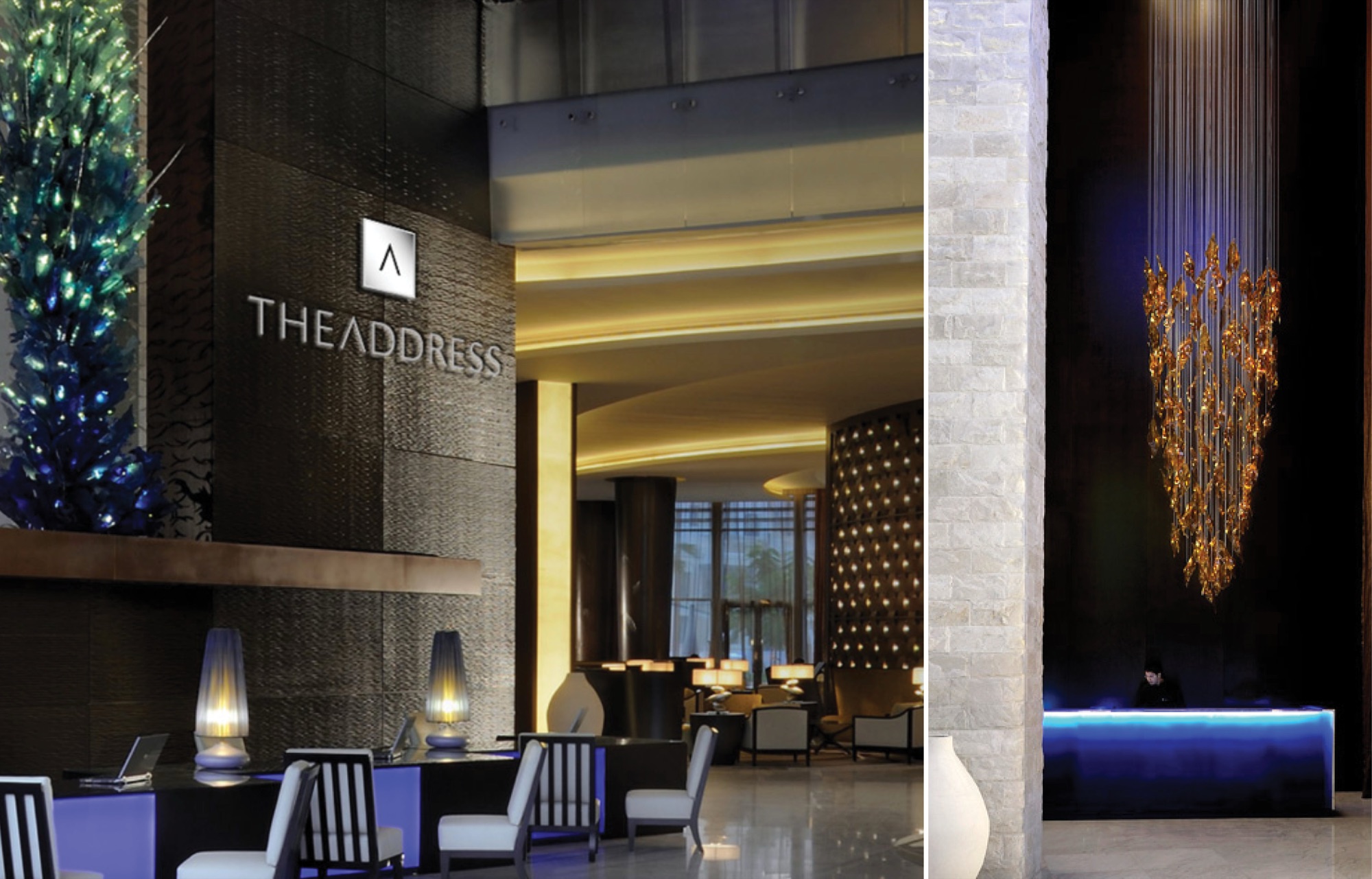 Hotel lobby and reception: the diamond A monogram and THEADDRESS wordmark in brushed steel on a dark textured stone wall, a tall blue and green glass sculpture alongside, backlit onyx beyond the desk, and a second view of a reception counter lit blue beneath a suspended amber glass chandelier